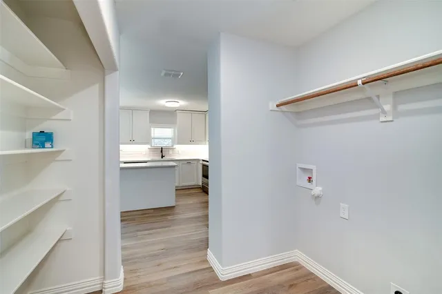 a view of a kitchen cabinets and wooden floor