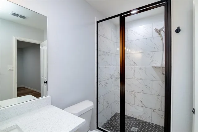 a bathroom with a shower and a toilet
