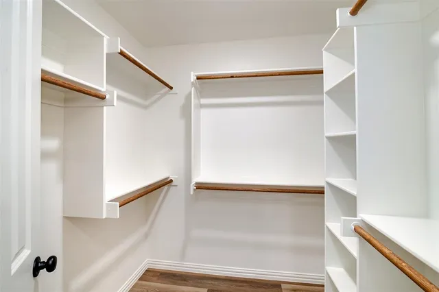 a view of closet with wooden floor