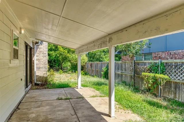 a backyard of a house with plants and outdoor seating