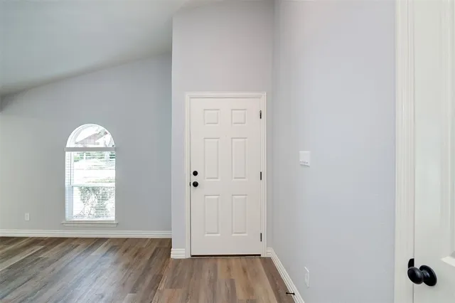 an empty room with windows and closet