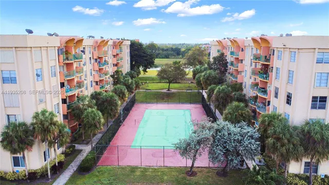 a view of lot of multi story residential apartment building with yard