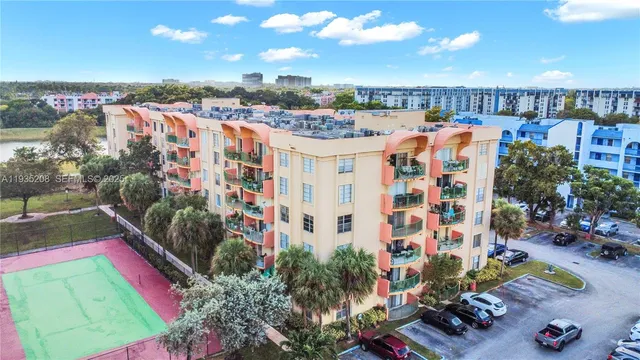 an aerial view of lake and residential houses with outdoor space