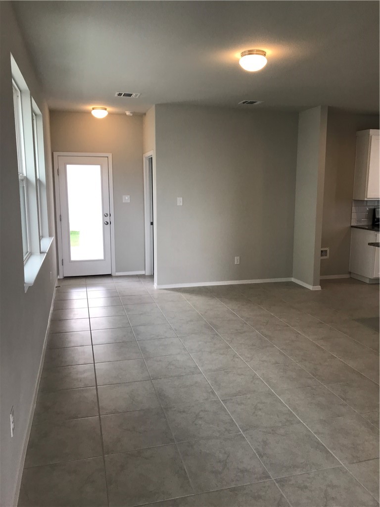 1353 Goforth Road Kyle, TX 78640 - Photo 12 of 24 a view of a hallway with an empty room and a window