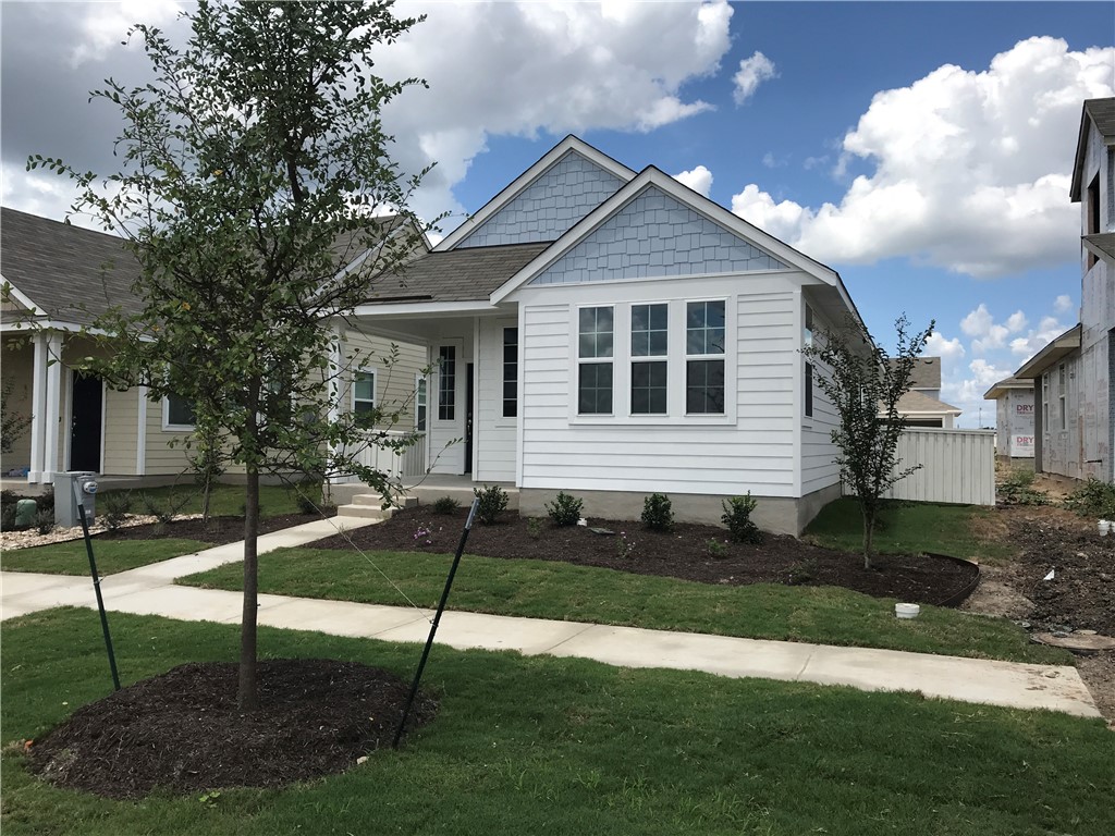 1353 Goforth Road Kyle, TX 78640 - Photo 3 of 24 a front view of a house with a yard