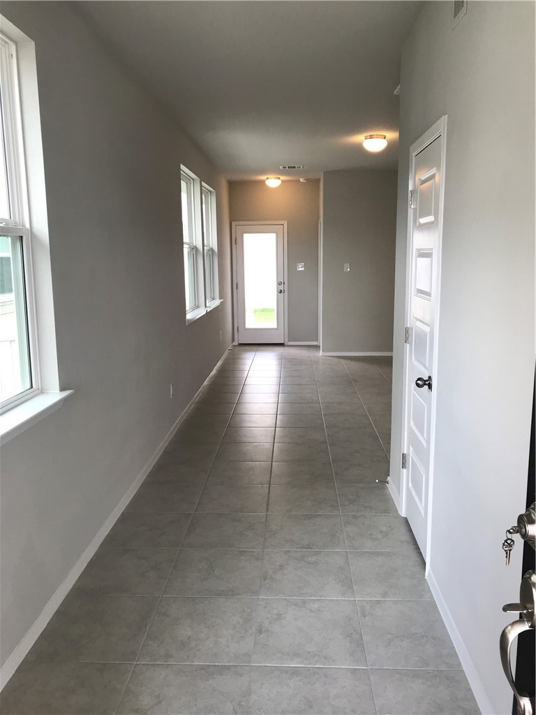 1353 Goforth Road Kyle, TX 78640 - Photo 4 of 24 a view of hallway with windows and chandelier