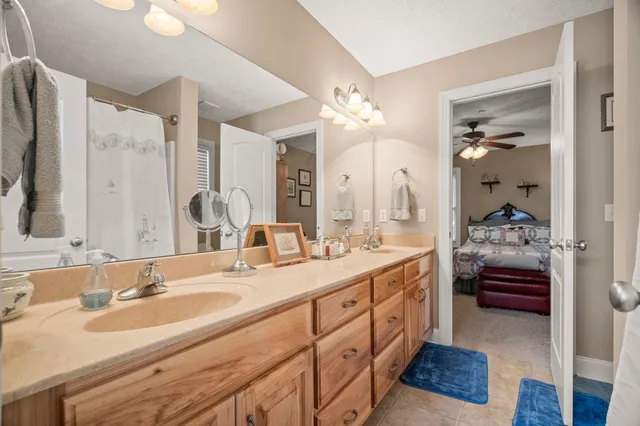 a en suite bathroom with double vanity and a mirror