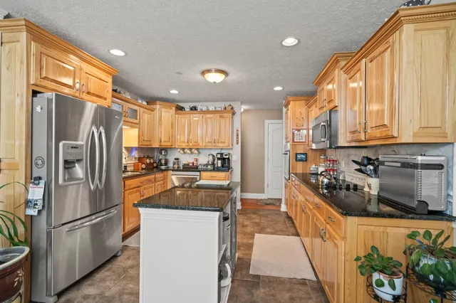 a kitchen with refrigerator a stove and a refrigerator