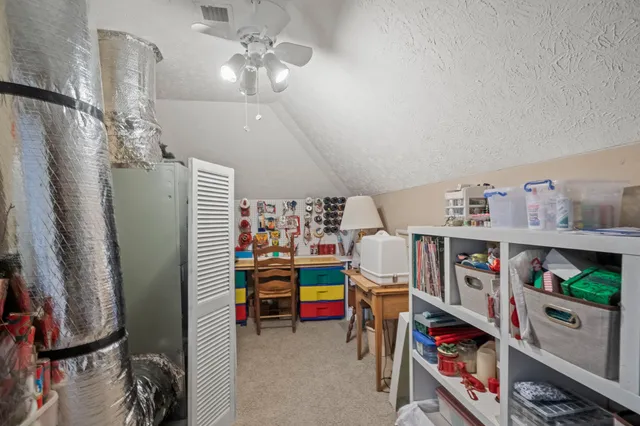 a bedroom with furniture and a book shelf