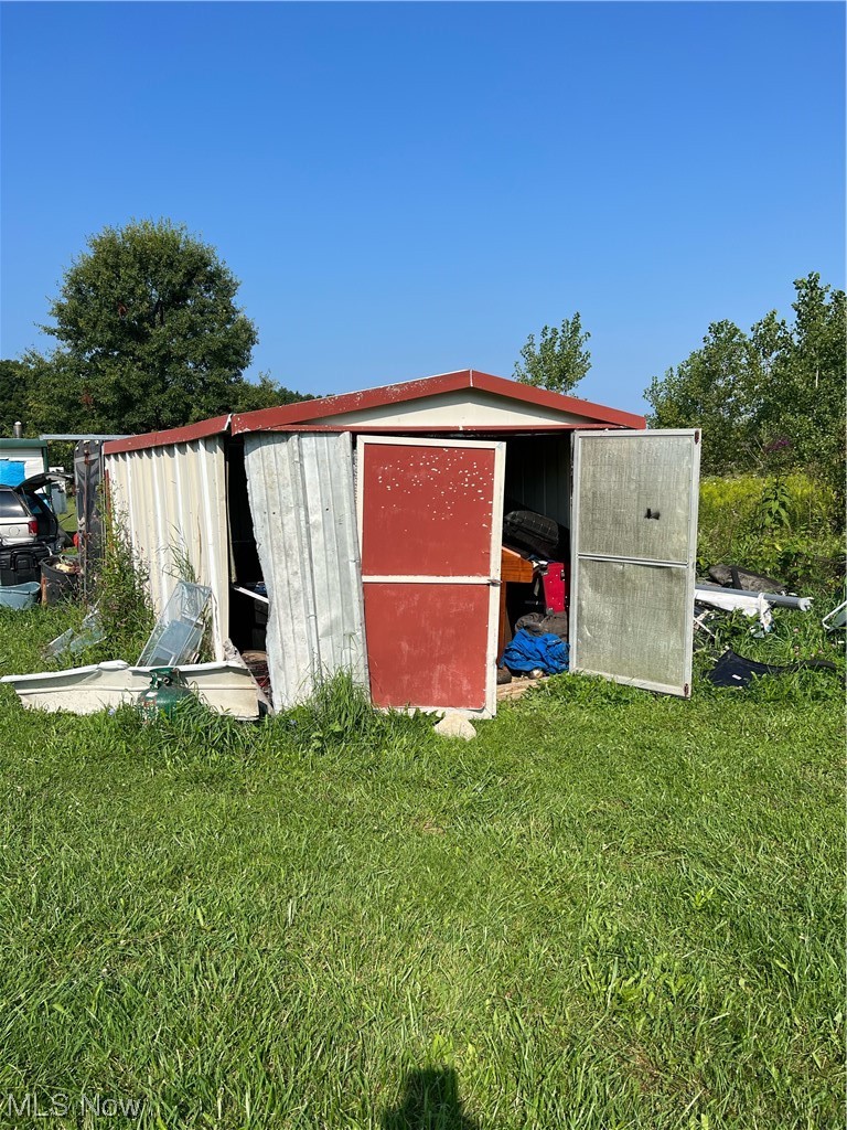 11184 Stratton Road West Salem, OH 44287 - Photo 4 of 9 View of outdoor structure with a yard and a storage shed