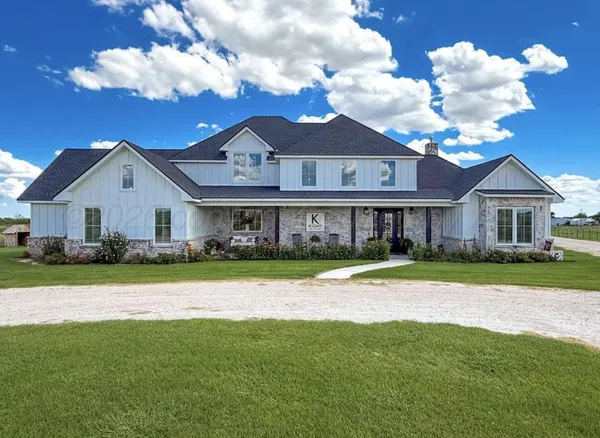 a front view of a house with a yard and porch