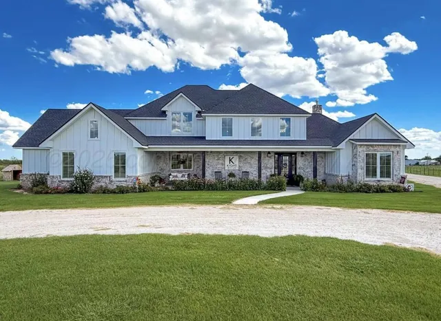 a front view of a house with a yard and porch