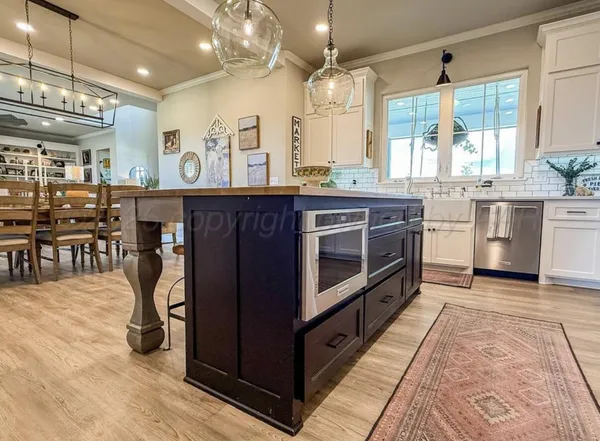a kitchen with stainless steel appliances granite countertop a stove and cabinets