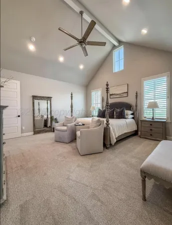 a living room with furniture and a ceiling fan