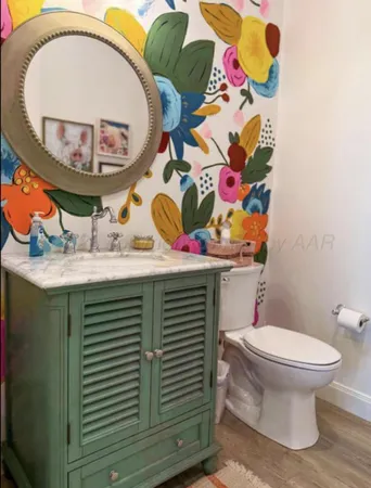 a bathroom with a sink mirror and toilet