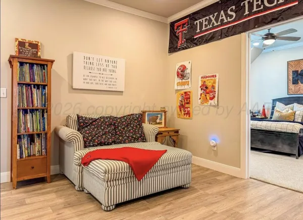 a living room with furniture and a book shelf