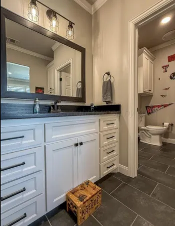 a bathroom with a granite countertop sink and a mirror