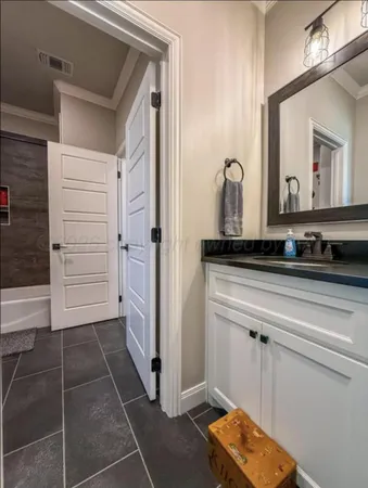 a bathroom with a mirror and a shower