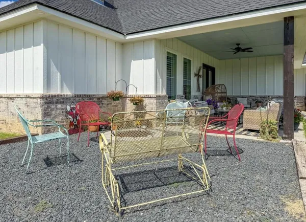 a view of a chairs and tables in the back yard