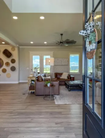 a living room with furniture and a chandelier