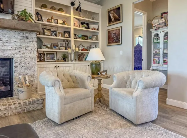 a living room with furniture and a book shelf
