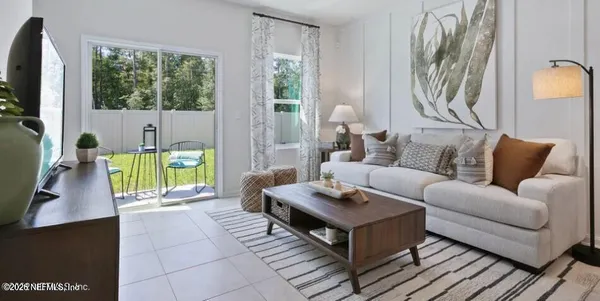 a living room with furniture and a flat screen tv