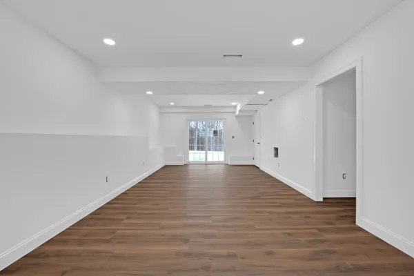 a bathroom with a granite countertop shower and a mirror