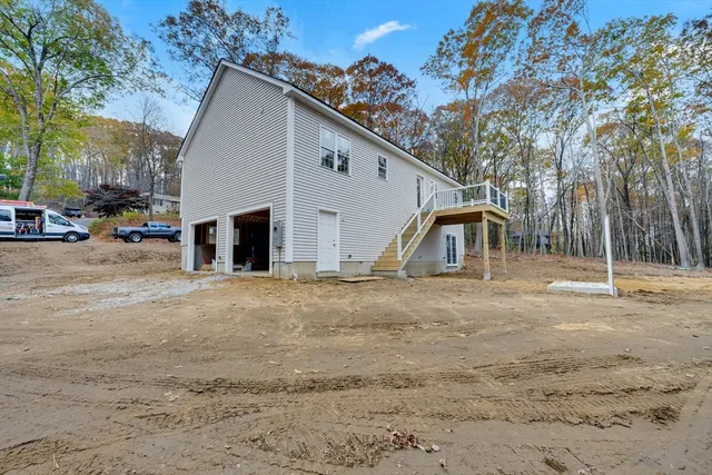 a view of a house with a yard and garage