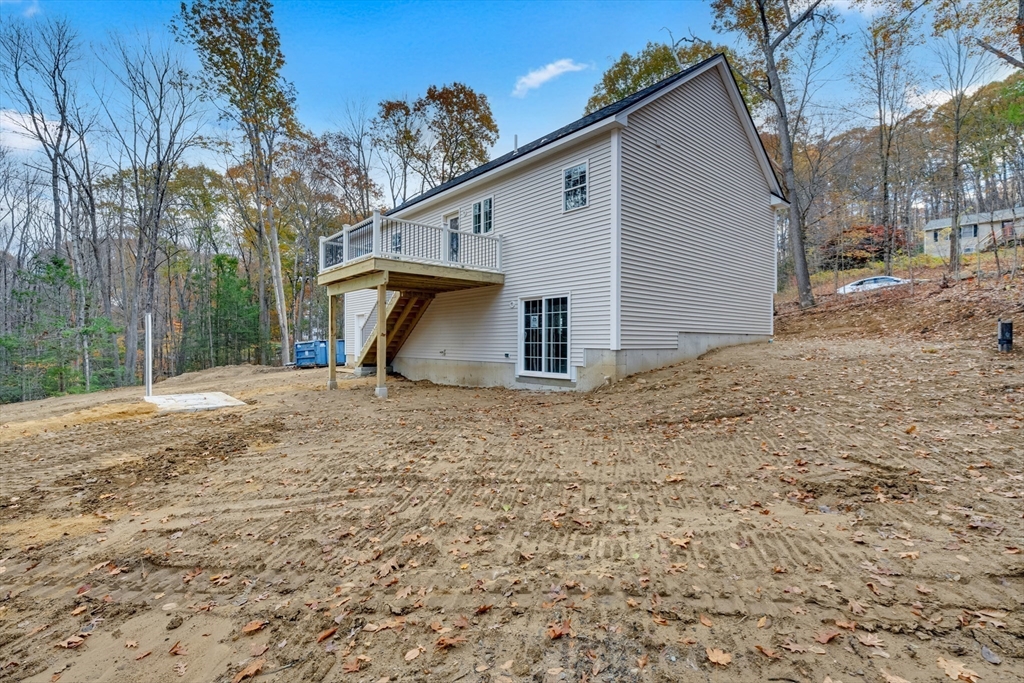 87 Vinton Road Sturbridge, MA 01566 - Photo 7 of 20 a view of a house with backyard and trees