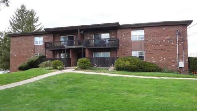 77 Balance Rock Road, Unit 7 Seymour, CT 06483 - Photo 1 of 1 a view of a brick house with a big yard and large trees
