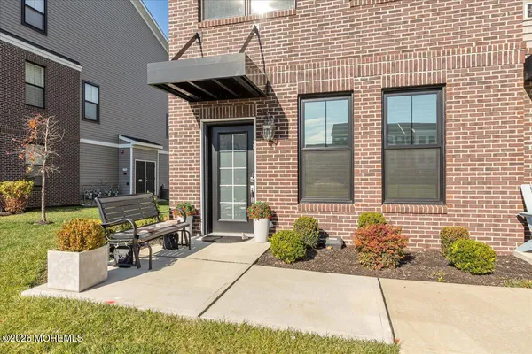 a front view of a house with a garden and patio