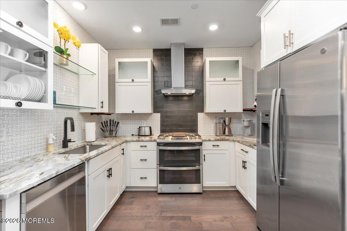 29 Midway Road North Tinton Falls, NJ 07724 - Photo 35 of 37 a kitchen with a sink stove and refrigerator