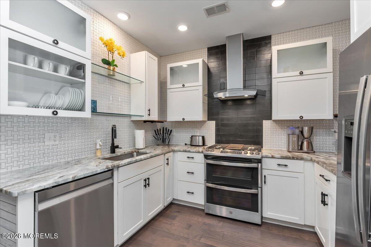 29 Midway Road North Tinton Falls, NJ 07724 - Photo 36 of 37 a kitchen with stainless steel appliances granite countertop a sink and cabinets
