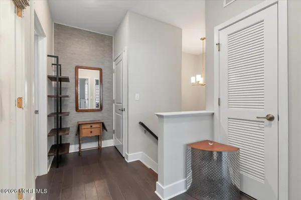 a view of a room with wooden floor and furniture