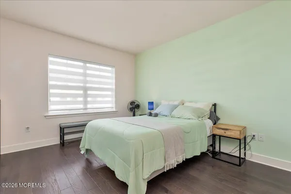 a bedroom with a bed table and a window