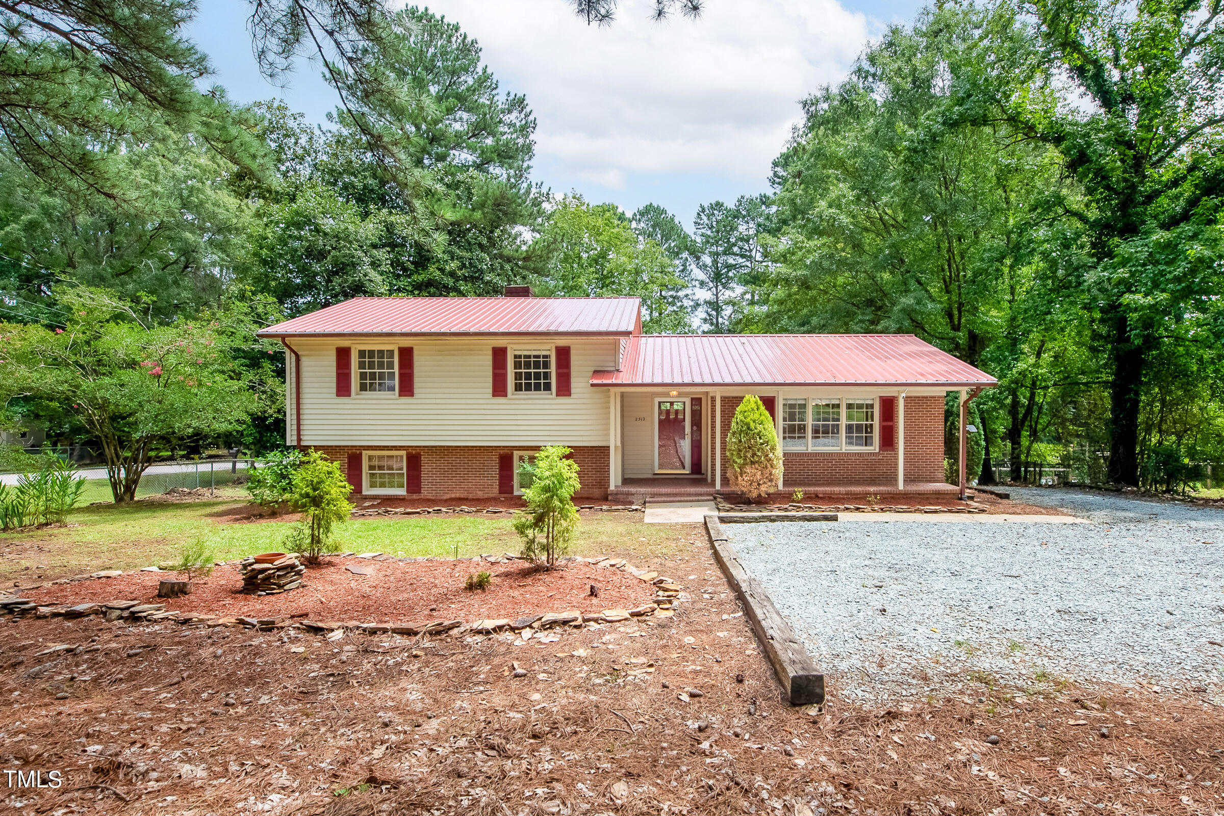 2512 Sparger Road Durham, NC 27705 - Photo 1 of 29 a view of a house with a yard and large tree