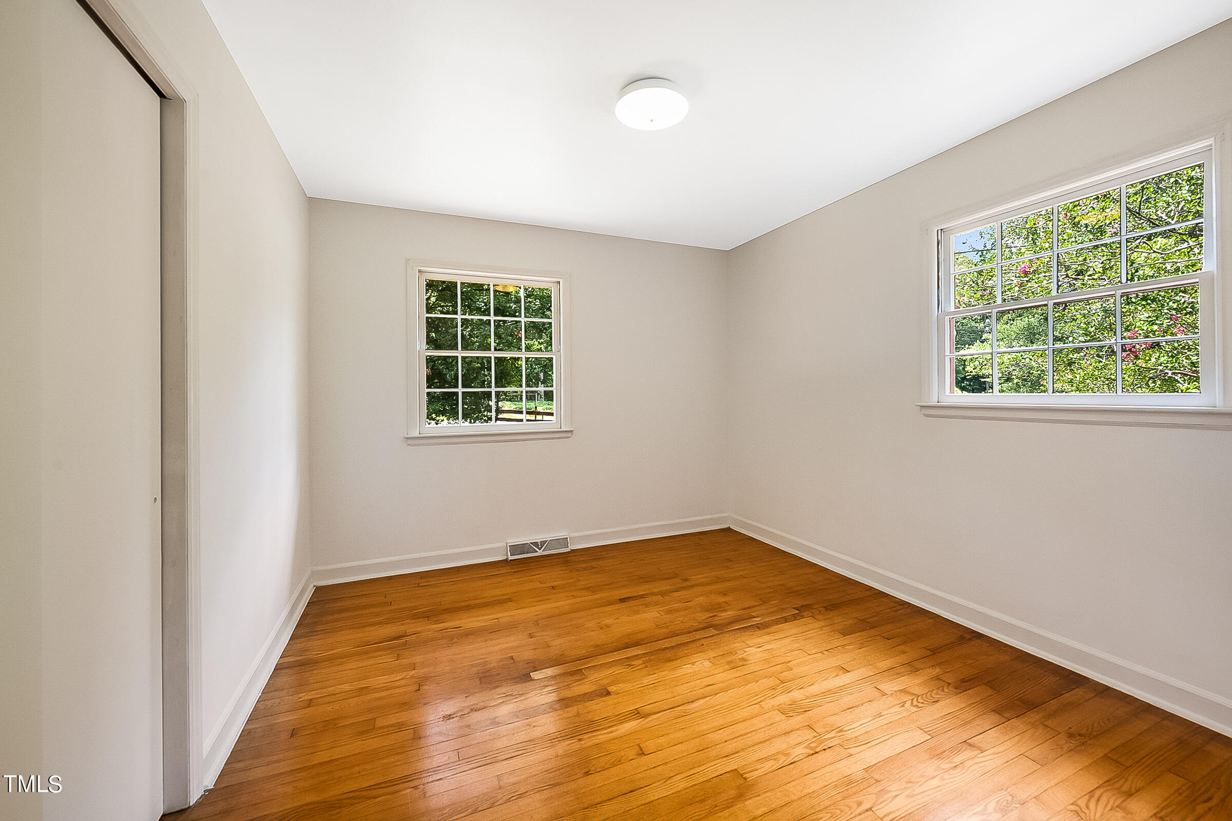 2512 Sparger Road Durham, NC 27705 - Photo 16 of 29 a view of an empty room with wooden floor and a window