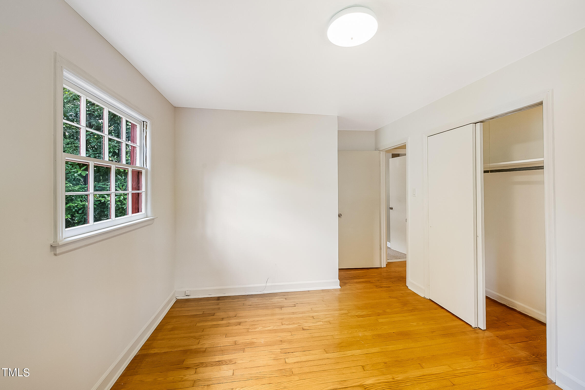 2512 Sparger Road Durham, NC 27705 - Photo 17 of 29 a view of an empty room with wooden floor and a window