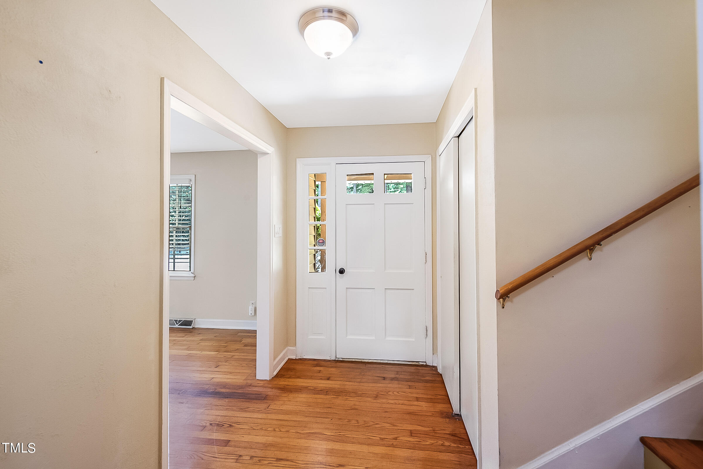 2512 Sparger Road Durham, NC 27705 - Photo 2 of 29 a view of a hallway with wooden floor and staircase