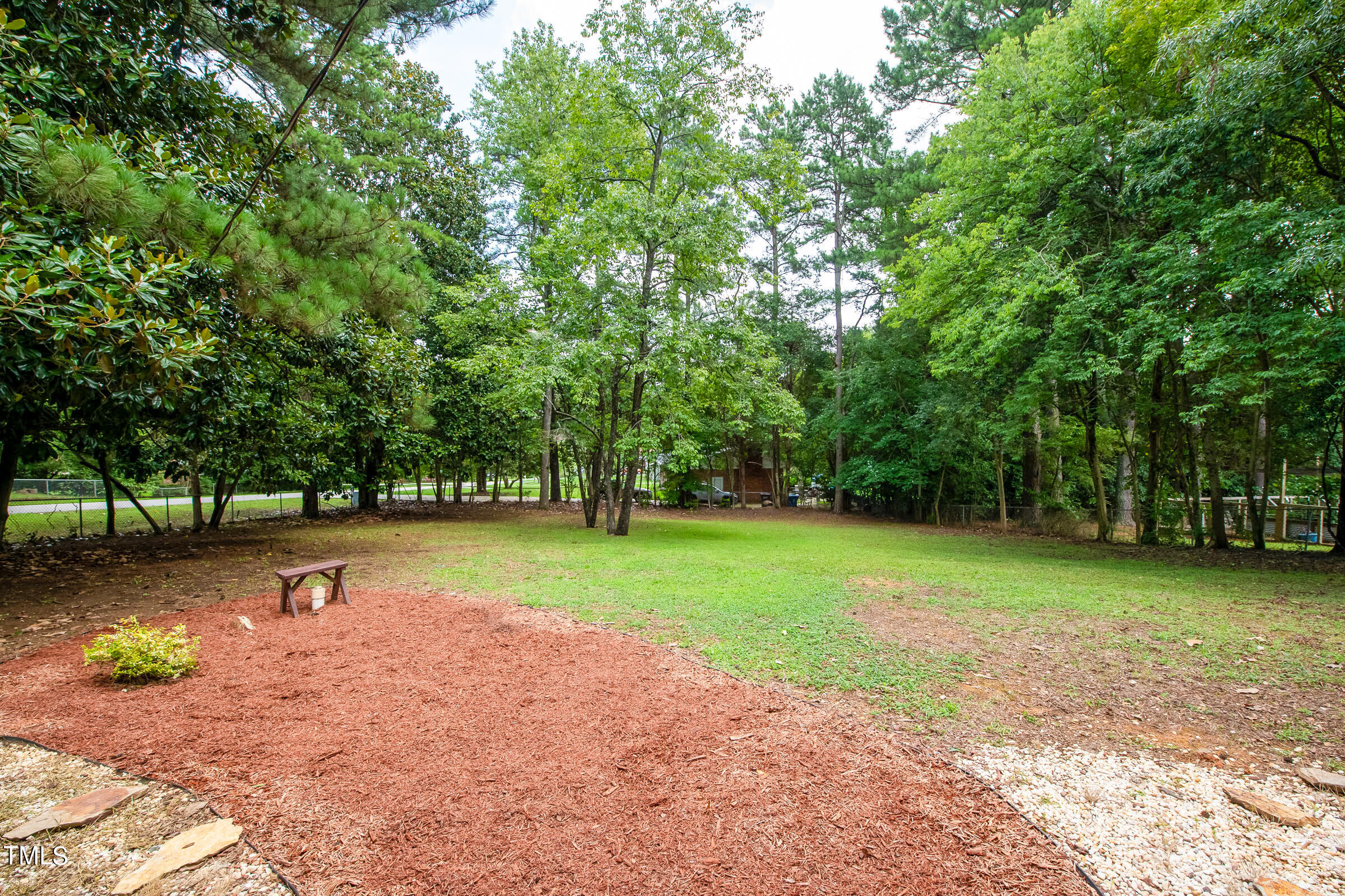 2512 Sparger Road Durham, NC 27705 - Photo 29 of 29 a view of outdoor space with deck and trees