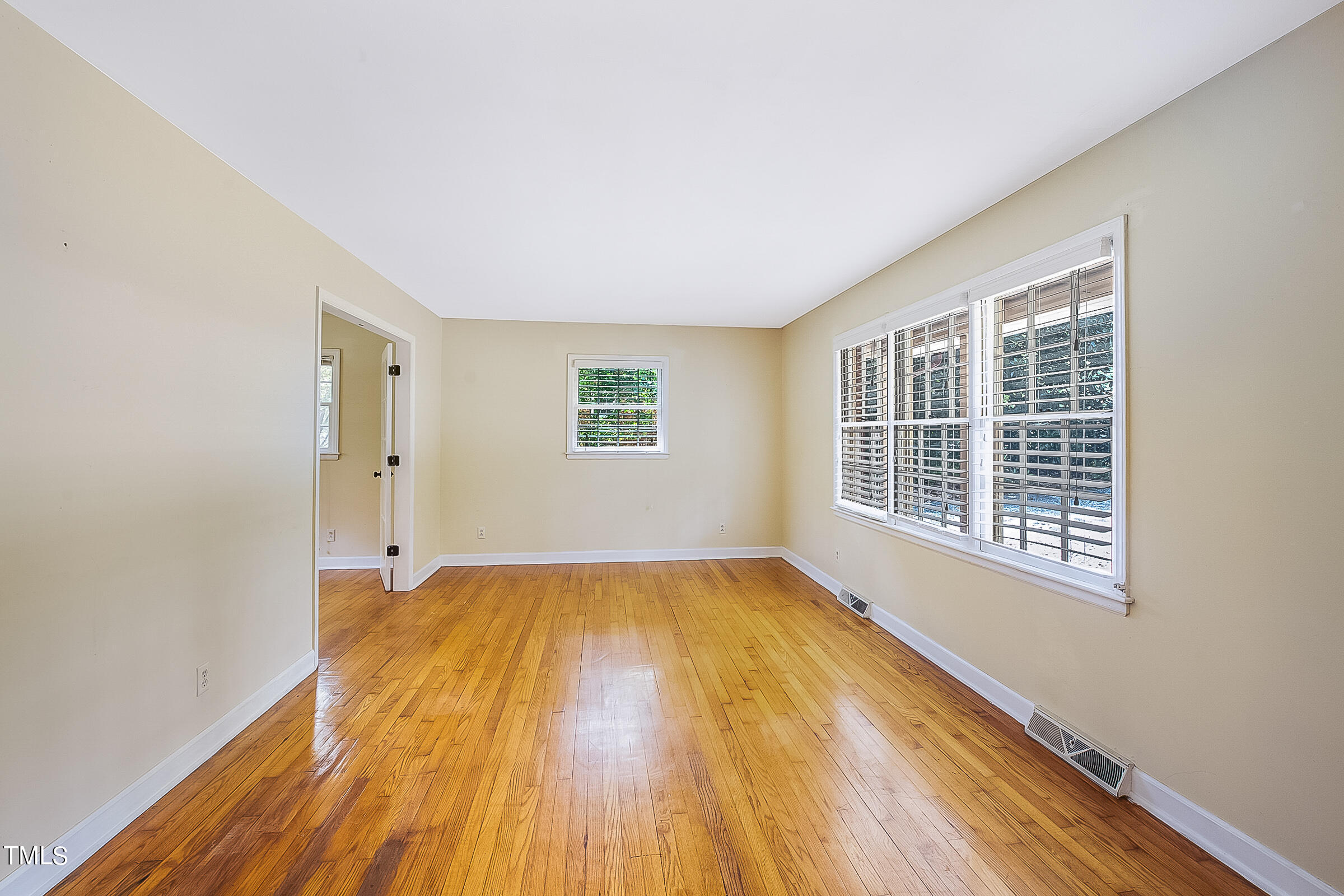 2512 Sparger Road Durham, NC 27705 - Photo 3 of 29 a view of an empty room with wooden floor and a window