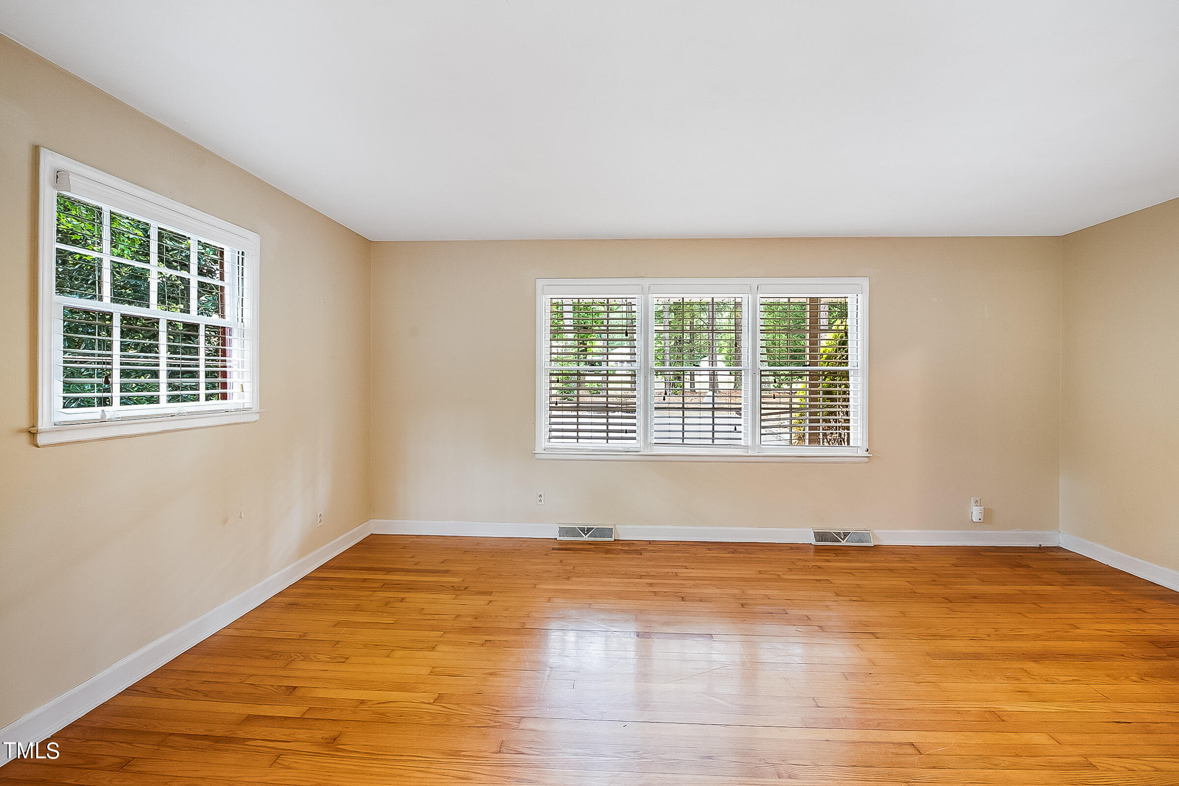 2512 Sparger Road Durham, NC 27705 - Photo 4 of 29 a view of an empty room with wooden floor and a window