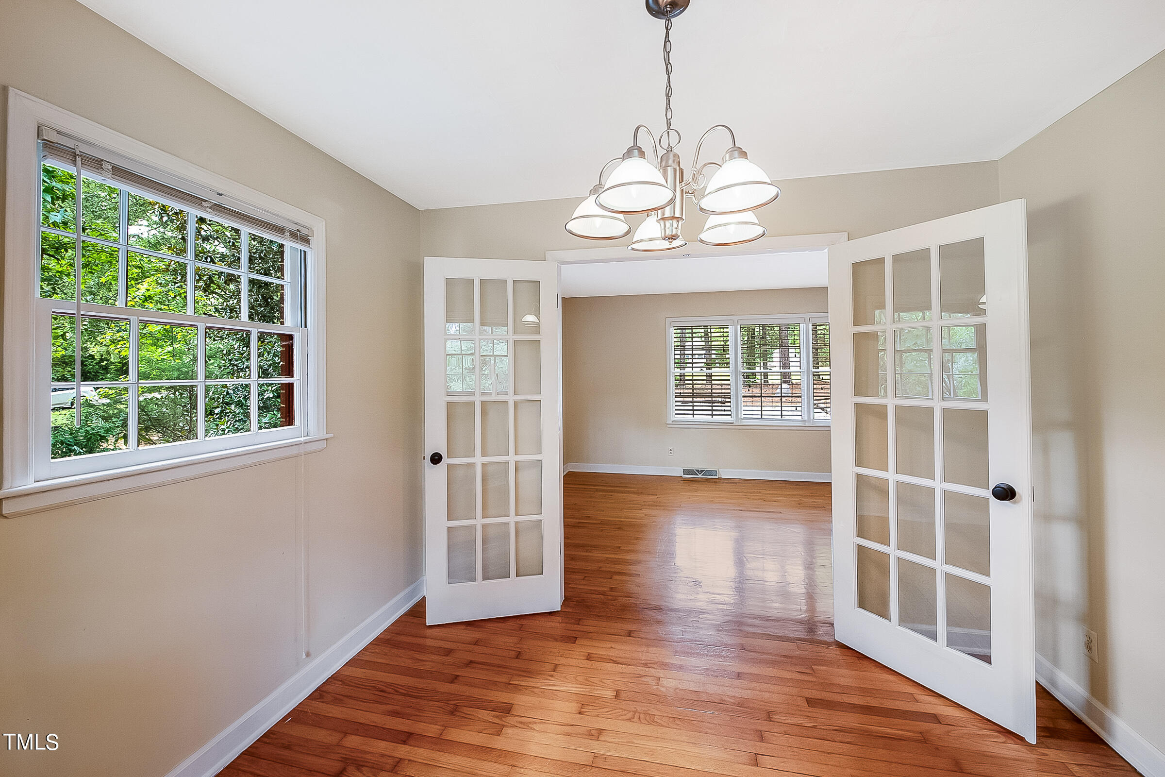 2512 Sparger Road Durham, NC 27705 - Photo 6 of 29 a view of an empty room with wooden floor and a window