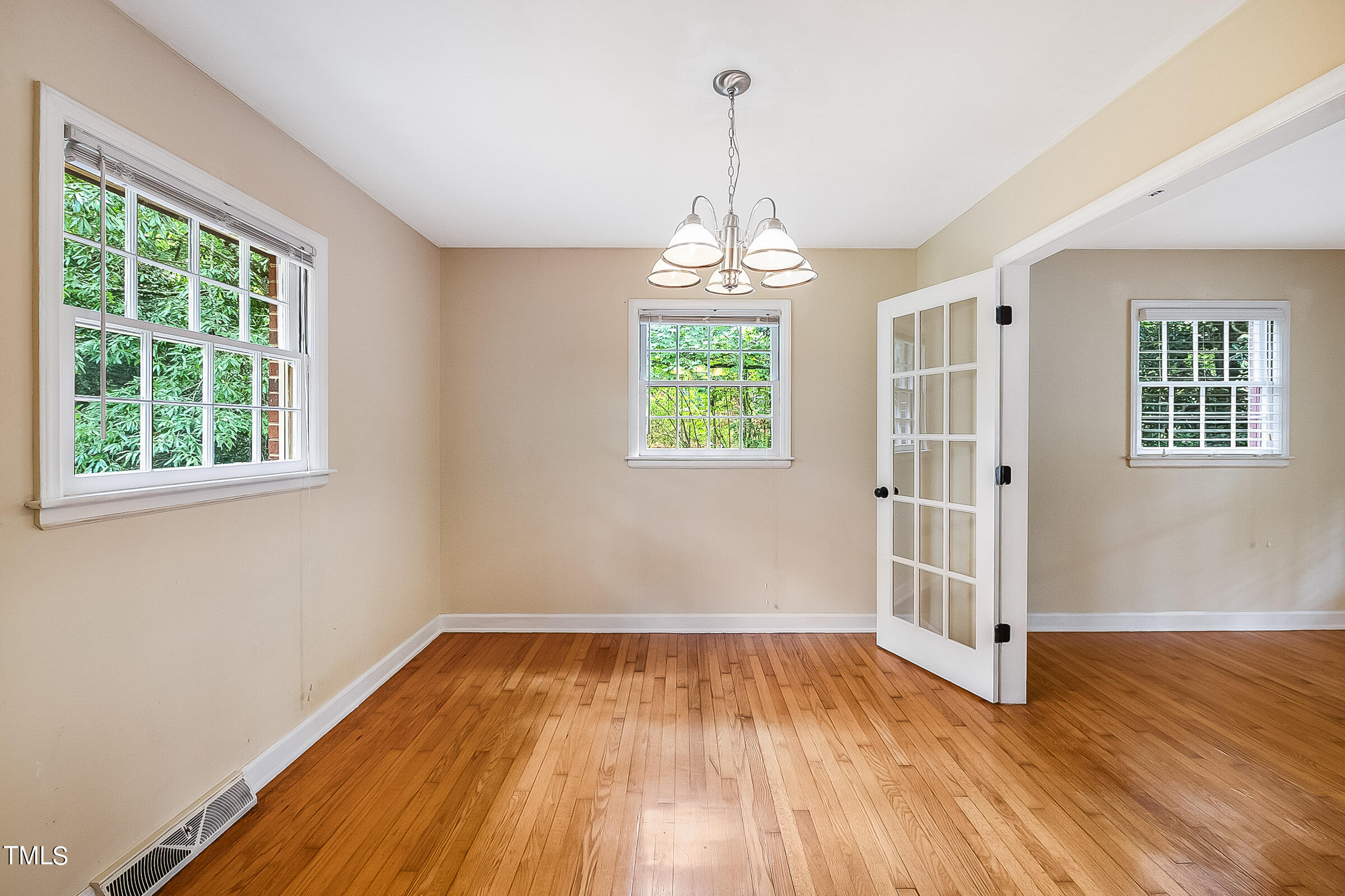 2512 Sparger Road Durham, NC 27705 - Photo 7 of 29 a view of empty room with wooden floor and fan