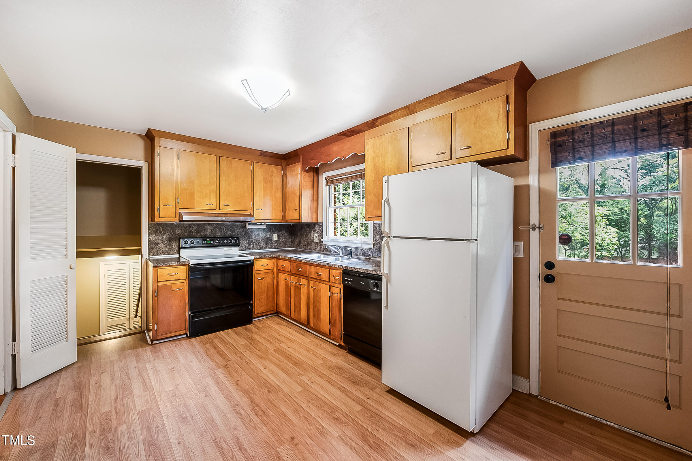 2512 Sparger Road Durham, NC 27705 - Photo 9 of 29 a kitchen with a refrigerator a stove top oven and a refrigerator