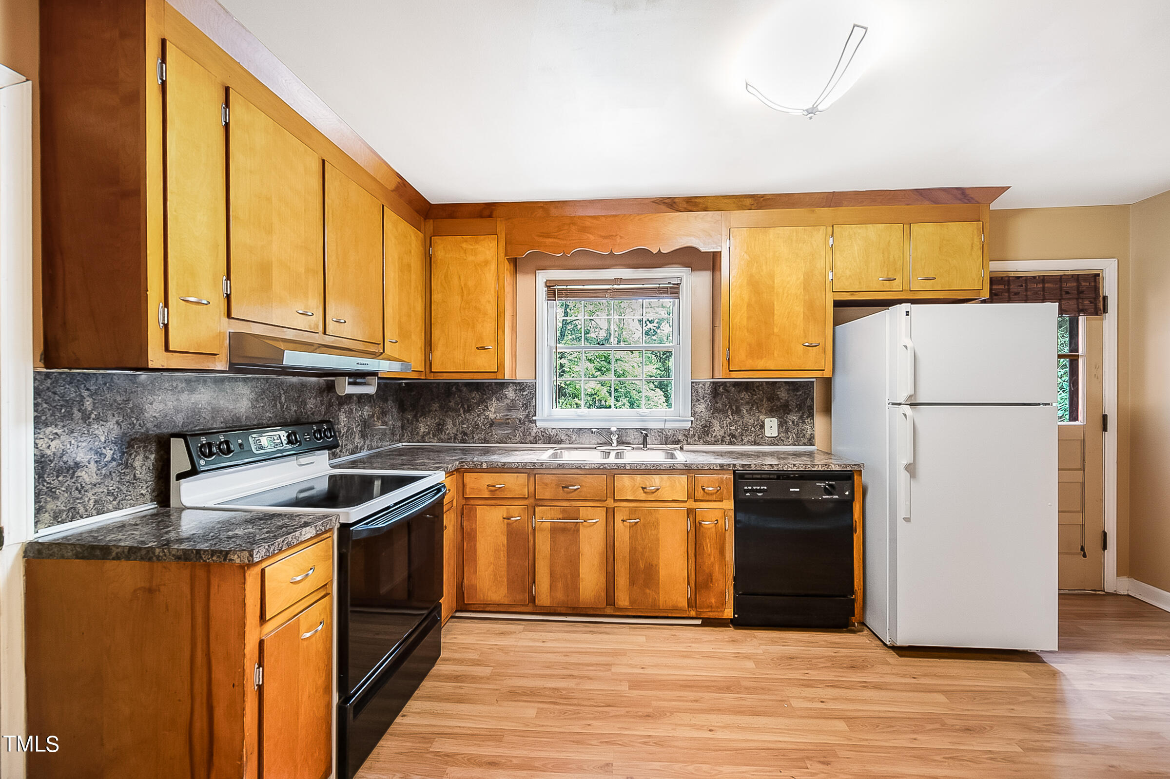 2512 Sparger Road Durham, NC 27705 - Photo 10 of 29 a kitchen with stainless steel appliances granite countertop a refrigerator a sink dishwasher a stove top oven a refrigerator and white cabinets with wooden floor