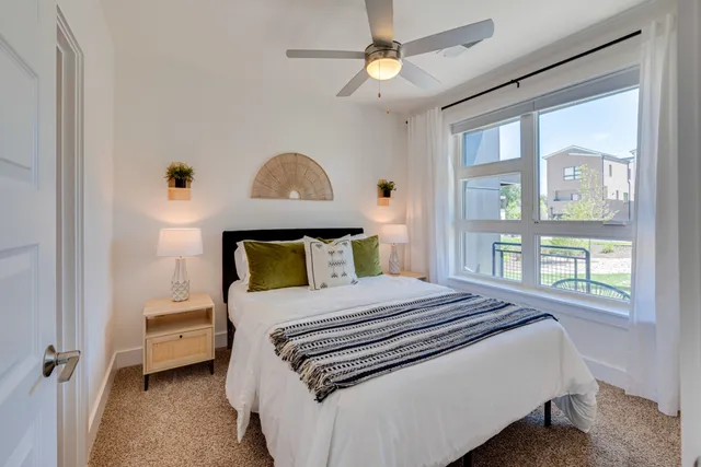 a bed sitting in a bedroom next to a lamp