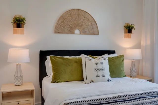 a bedroom with a bed and a night stand