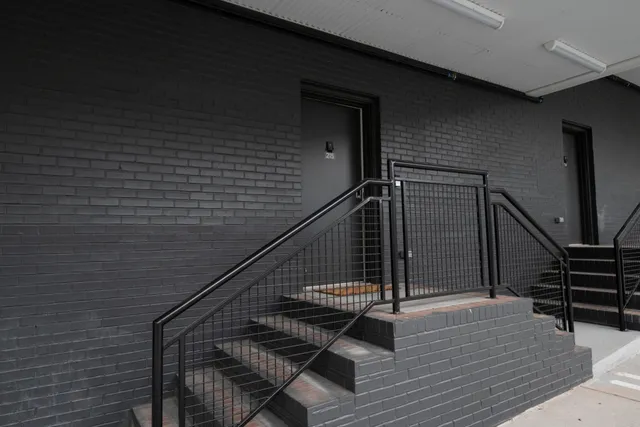 a bedroom with a bed and cabinet