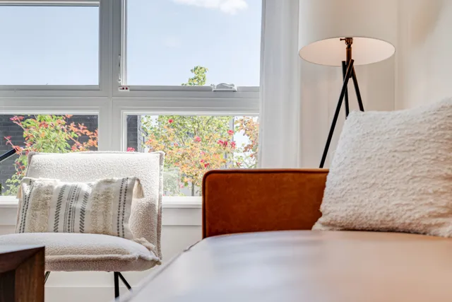 a living room with furniture and a lamp